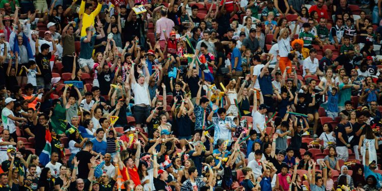 Fans celebrating in a football stadium, world cup